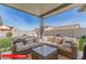 Relaxing outdoor patio with comfortable sectional seating and clear views of the backyard at 11679 W Parkway Ln, Avondale, AZ 85323