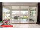 View of the patio through sliding glass doors featuring a covered seating area and a backyard at 11679 W Parkway Ln, Avondale, AZ 85323
