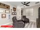 Cozy sitting area featuring comfortable armchairs, a ceiling fan, and tasteful wall decor at 11679 W Parkway Ln, Avondale, AZ 85323