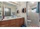 Well-lit bathroom with a double sink vanity and a separate toilet and shower area at 12443 W Monte Vista Rd, Avondale, AZ 85323