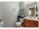 Powder room with tiled floors, mint green walls, and wood vanity at 12443 W Monte Vista Rd, Avondale, AZ 85323