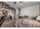 A bedroom featuring a large mirror, a shelving unit for shoe storage, and a comfortable bed at 12443 W Monte Vista Rd, Avondale, AZ 85323