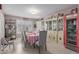 Charming dining room with a vintage Coca-Cola refrigerator, elegant china cabinet, and stylish furnishings at 12443 W Monte Vista Rd, Avondale, AZ 85323