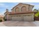 Beautiful two-story home with a three-car garage and mature landscaping at 12443 W Monte Vista Rd, Avondale, AZ 85323