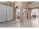 Elegant foyer with white double doors and an open view to the formal dining room at 12443 W Monte Vista Rd, Avondale, AZ 85323