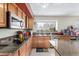 Functional kitchen with granite countertops, stainless steel appliances, and ample storage space at 12443 W Monte Vista Rd, Avondale, AZ 85323