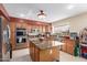 Bright kitchen with a large island, stainless steel appliances, and efficient design at 12443 W Monte Vista Rd, Avondale, AZ 85323