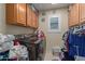 Well-equipped laundry room with a modern washer and dryer and ample storage cabinets at 12443 W Monte Vista Rd, Avondale, AZ 85323