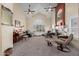 Bright living room with fireplace, vaulted ceilings and large arched windows at 12443 W Monte Vista Rd, Avondale, AZ 85323