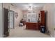 View of home office with custom wood desk, tile floors, and abundant natural light at 12443 W Monte Vista Rd, Avondale, AZ 85323