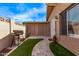 Quaint backyard includes artificial turf, stone pavers, and a barbecue at 1310 S Pima St # 34, Mesa, AZ 85210