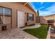 Backyard space has artificial turf, stone pavers, and a barbecue at 1310 S Pima St # 34, Mesa, AZ 85210