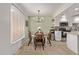 Charming dining area complemented by a modern chandelier and bright natural light at 1310 S Pima St # 34, Mesa, AZ 85210