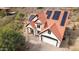 Aerial view of a home with red tile roofing, solar panels, and a two car garage at 1428 E Las Palmaritas Dr, Phoenix, AZ 85020