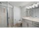 Bright bathroom with a glass enclosed shower, marble vanity and updated lighting at 1428 E Las Palmaritas Dr, Phoenix, AZ 85020