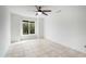 Bedroom with ceiling fan, neutral palette, and large window view at 1428 E Las Palmaritas Dr, Phoenix, AZ 85020