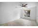 Neutral bedroom with a window letting in natural light and a ceiling fan at 1428 E Las Palmaritas Dr, Phoenix, AZ 85020