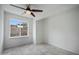 Bright bedroom with desert views from a window and ceiling fan at 1428 E Las Palmaritas Dr, Phoenix, AZ 85020