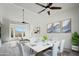 Dining room featuring modern furnishings, a ceiling fan, and views of the landscape at 1428 E Las Palmaritas Dr, Phoenix, AZ 85020