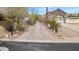 Long driveway is paved with brick and surrounded by desert vegetation at 1428 E Las Palmaritas Dr, Phoenix, AZ 85020