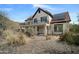 Exterior view displaying desert landscaping, tile roof, and a second-story balcony at 1428 E Las Palmaritas Dr, Phoenix, AZ 85020