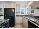 Open kitchen featuring granite countertops, white cabinetry, and stainless steel appliances at 1428 E Las Palmaritas Dr, Phoenix, AZ 85020