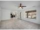 Open-concept living room with large window and tile floors lead to modern kitchen at 1428 E Las Palmaritas Dr, Phoenix, AZ 85020