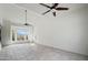 Bright living room featuring neutral tile flooring, ceiling fans, and large view windows at 1428 E Las Palmaritas Dr, Phoenix, AZ 85020