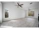 Spacious living room with neutral tile flooring, ceiling fans and a window with views at 1428 E Las Palmaritas Dr, Phoenix, AZ 85020