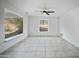 Spacious living room area featuring tiled floors, ceiling fan and large view windows at 1428 E Las Palmaritas Dr, Phoenix, AZ 85020