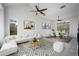 Bright living room with a ceiling fan, large windows, and an open dining area at 1428 E Las Palmaritas Dr, Phoenix, AZ 85020