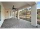 Spacious covered patio featuring brick pavers, a ceiling fan, and views of the surrounding landscape at 1428 E Las Palmaritas Dr, Phoenix, AZ 85020