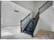 Open floor plan with staircase featuring black handrails and a modern ceiling fan at 1428 E Las Palmaritas Dr, Phoenix, AZ 85020