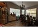 Dining room featuring a chandelier, wood-look flooring, and bright natural light at 14440 N 56Th Pl, Scottsdale, AZ 85254