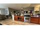 Well-lit kitchen featuring a breakfast bar with stainless appliances and wood-look floors at 14440 N 56Th Pl, Scottsdale, AZ 85254