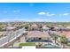 Backyard aerial shot shows a lush outdoor area, complete with a pool, an artificial lawn, and shade at 14612 W Edgemont Ave, Goodyear, AZ 85395