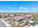 This aerial view displays an organized backyard, featuring a pool, artificial turf, covered areas, and native landscaping at 14612 W Edgemont Ave, Goodyear, AZ 85395