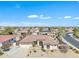 This aerial showcases the home's lush landscaping, desert terrain, and roofline with solar panels in the community at 14612 W Edgemont Ave, Goodyear, AZ 85395