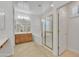 Expansive bathroom with a walk-in shower, soaking tub, and and vanities with wood cabinetry at 14612 W Edgemont Ave, Goodyear, AZ 85395