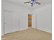 Bedroom featuring carpet, ceiling fan and closet, with a door that leads to another room at 14612 W Edgemont Ave, Goodyear, AZ 85395