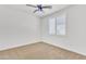 Bedroom featuring carpet, white plantation shutters, and a ceiling fan at 14612 W Edgemont Ave, Goodyear, AZ 85395