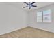 Clean, carpeted bedroom with a ceiling fan and white window shutters at 14612 W Edgemont Ave, Goodyear, AZ 85395