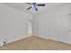 Bedroom featuring carpet, ceiling fan and closet, with a door that leads to another room at 14612 W Edgemont Ave, Goodyear, AZ 85395