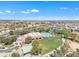 An aerial view of the community pool and surrounding recreational facilities, including a playground at 14612 W Edgemont Ave, Goodyear, AZ 85395