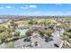 Aerial view of the community pool and rec center with manicured green spaces and a golf course backdrop at 14612 W Edgemont Ave, Goodyear, AZ 85395