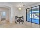 Bright dining area with a table and chairs, and a sliding glass door to the backyard at 14612 W Edgemont Ave, Goodyear, AZ 85395