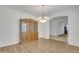 Open dining room with a decorative hutch, wood floors and decorative light fixture at 14612 W Edgemont Ave, Goodyear, AZ 85395