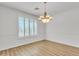 Bright dining room with wood flooring, decorative light fixture, and plantation shutters at 14612 W Edgemont Ave, Goodyear, AZ 85395