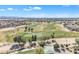 Aerial view of the golf course features lush fairways and strategically placed water hazards, set in the community at 14612 W Edgemont Ave, Goodyear, AZ 85395