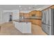 Bright kitchen with an island, stainless steel appliances, and wooden cabinets at 14612 W Edgemont Ave, Goodyear, AZ 85395